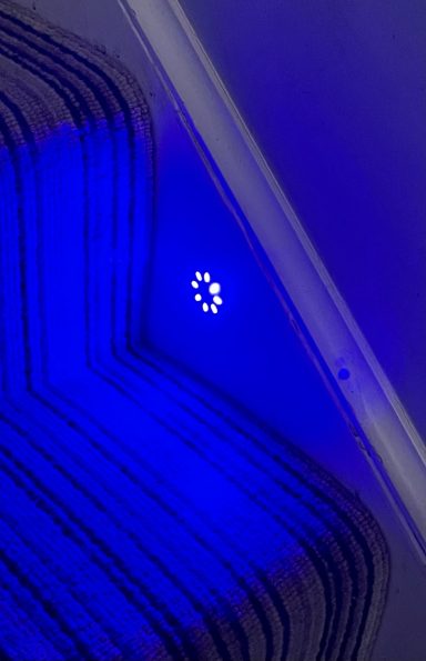 Blue lights on the side of a staircase