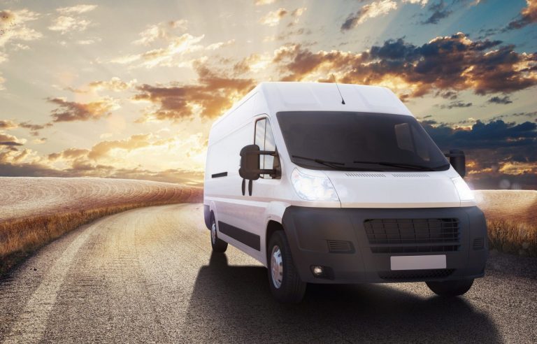 Picture of an electrician's van driving on a road